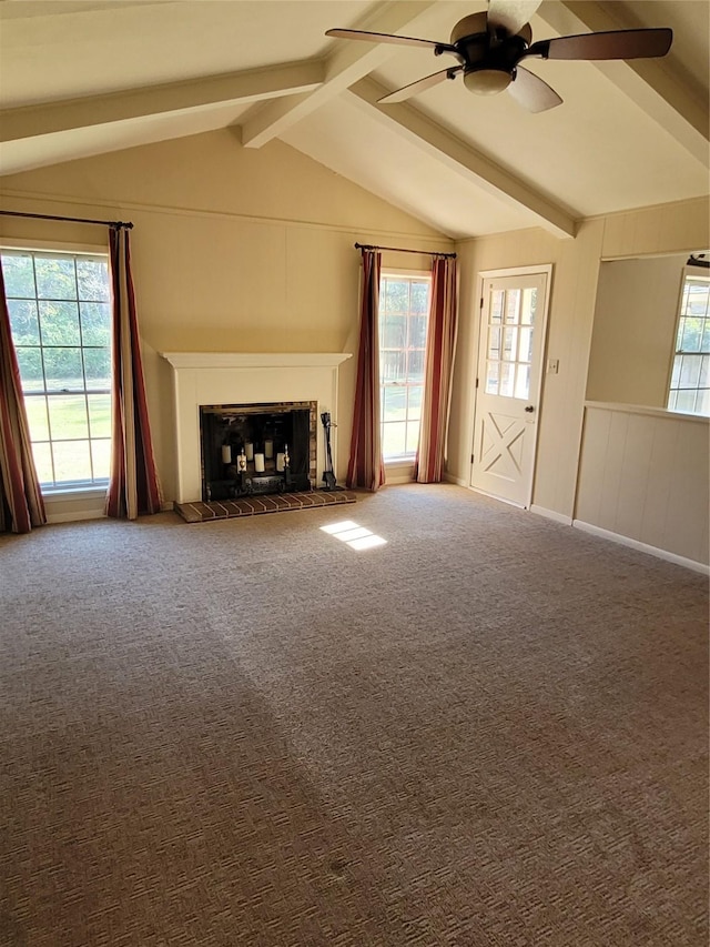 unfurnished living room with carpet flooring, ceiling fan, and lofted ceiling with beams