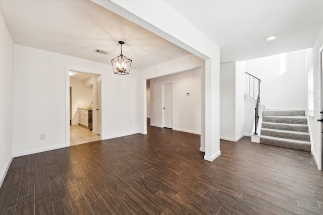 unfurnished living room with an inviting chandelier