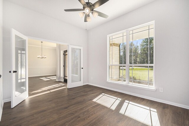 unfurnished bedroom featuring french doors, ceiling fan with notable chandelier, and dark wood-type flooring