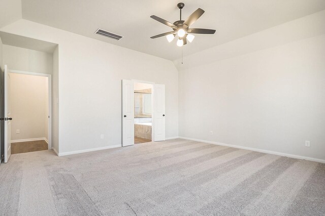 unfurnished bedroom with light carpet, ensuite bathroom, and ceiling fan