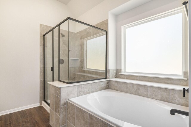 bathroom with hardwood / wood-style floors and separate shower and tub