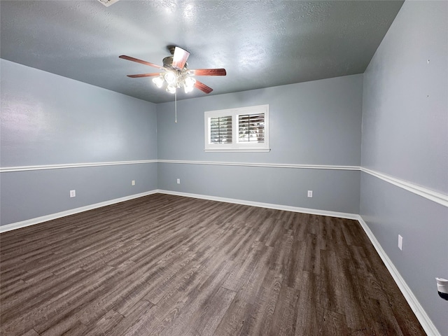 empty room with a textured ceiling, dark hardwood / wood-style flooring, and ceiling fan