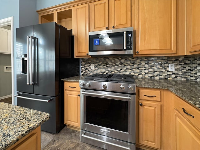 kitchen featuring tasteful backsplash, high quality appliances, and dark stone countertops