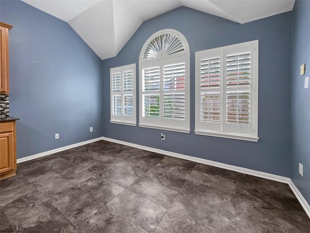 unfurnished dining area with vaulted ceiling