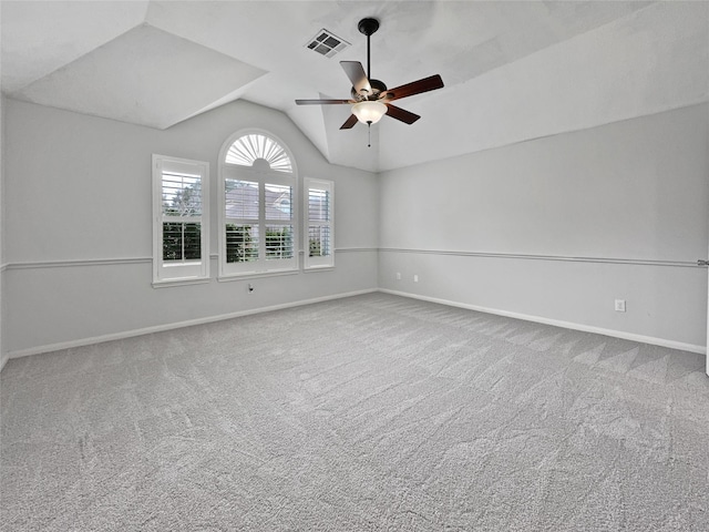 carpeted spare room featuring ceiling fan and lofted ceiling