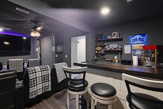 bar with dark hardwood / wood-style floors and ceiling fan