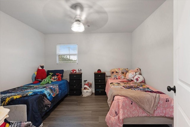 bedroom with ceiling fan and dark wood-type flooring