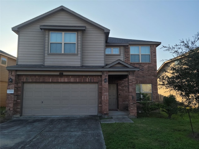 view of front of house featuring a garage and a lawn