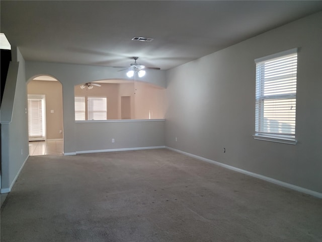 spare room featuring ceiling fan and light colored carpet