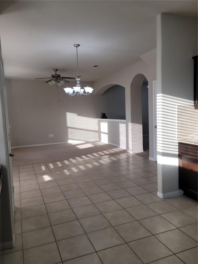 interior space featuring ceiling fan with notable chandelier and light tile patterned flooring