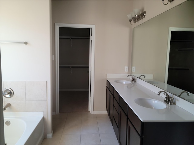 bathroom featuring tile patterned floors, vanity, and a bath