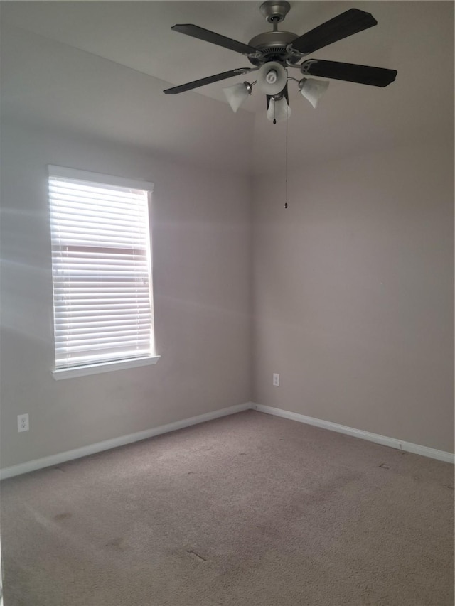 empty room featuring carpet flooring and ceiling fan