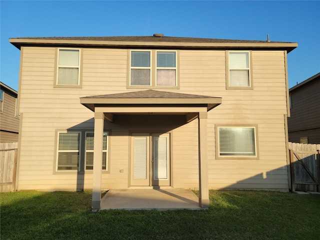 back of house featuring a yard and a patio