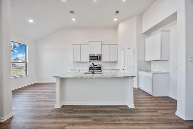 kitchen featuring white cabinetry, a center island with sink, stainless steel appliances, and sink