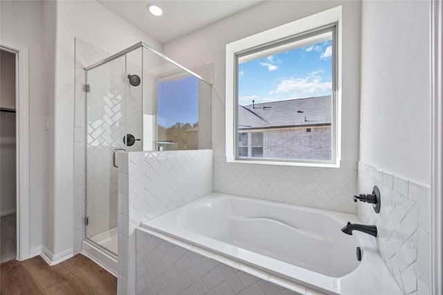 bathroom with plus walk in shower and wood-type flooring