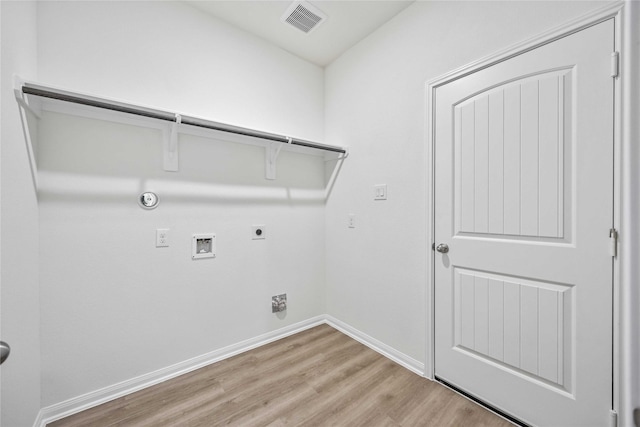 laundry area with hookup for an electric dryer, hookup for a washing machine, light hardwood / wood-style flooring, and gas dryer hookup