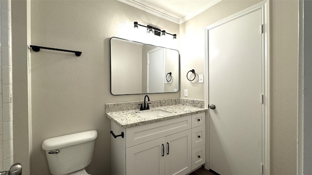 bathroom with vanity, toilet, and crown molding