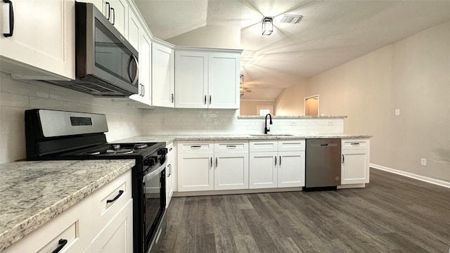 kitchen with white cabinetry, sink, light stone countertops, and appliances with stainless steel finishes