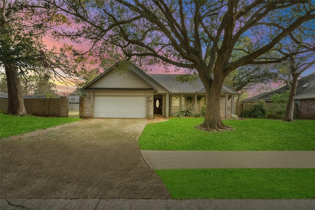 single story home featuring a yard and a garage