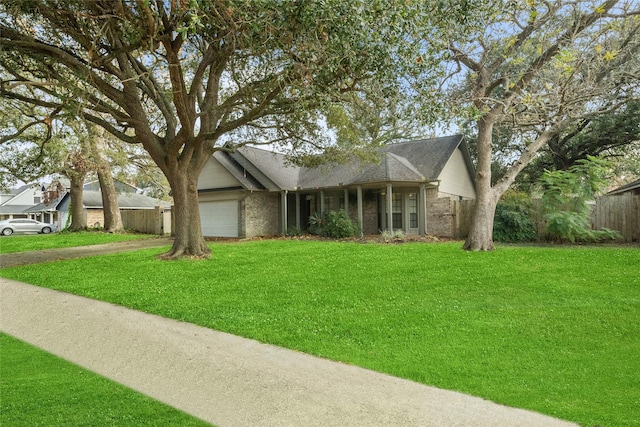 ranch-style house with a front yard and a garage