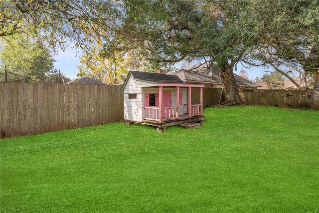 view of yard with a wooden deck and a storage shed