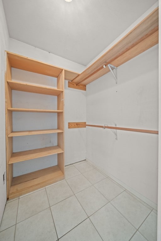 walk in closet with tile patterned floors