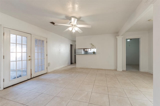 spare room featuring light tile patterned floors, french doors, and ceiling fan