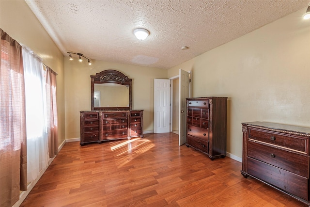 bedroom featuring a textured ceiling and hardwood / wood-style flooring