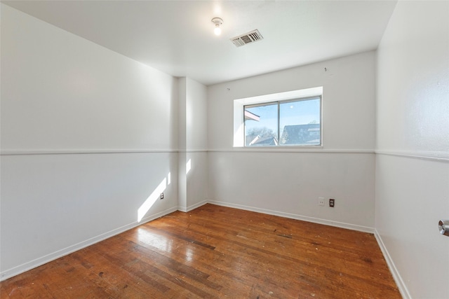 unfurnished room with hardwood / wood-style floors