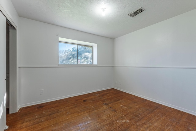 spare room featuring dark hardwood / wood-style flooring