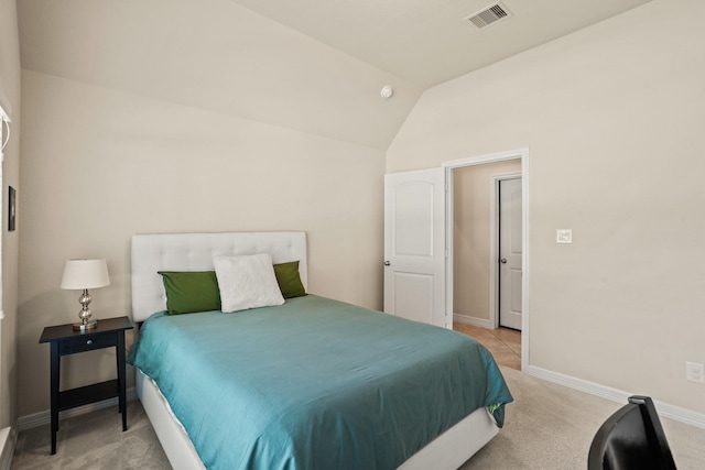 carpeted bedroom with vaulted ceiling