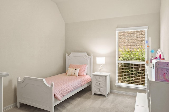 bedroom with light colored carpet, lofted ceiling, and multiple windows