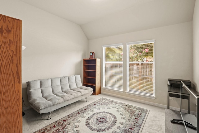 sitting room featuring light carpet and vaulted ceiling