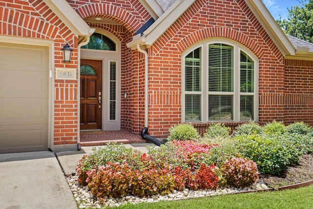 view of exterior entry with a garage