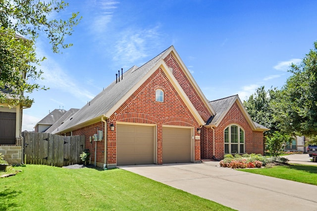 view of front of house featuring a garage and a front lawn