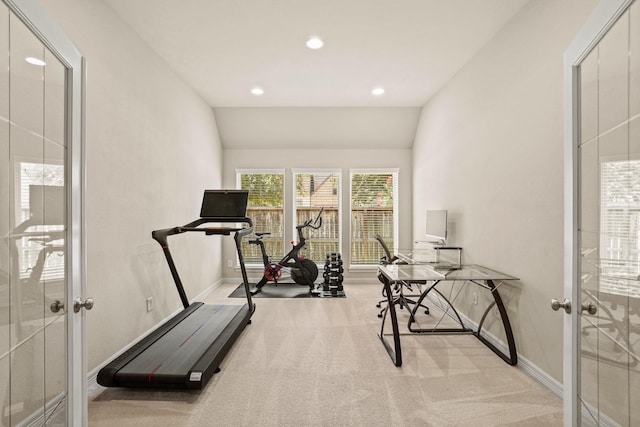 exercise room with french doors, light colored carpet, and vaulted ceiling