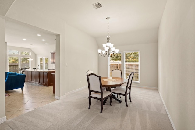 carpeted dining area with a chandelier, sink, and vaulted ceiling