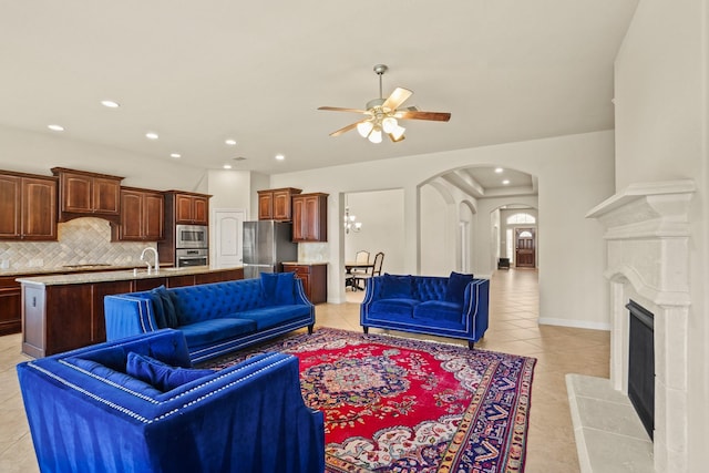 living room featuring light tile patterned floors and ceiling fan