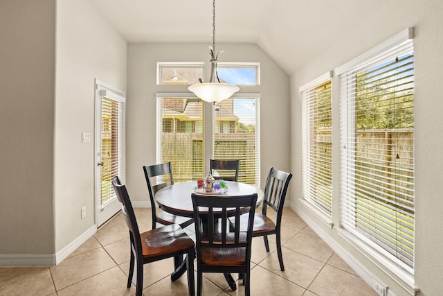 tiled dining room with vaulted ceiling