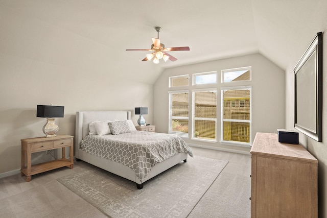 carpeted bedroom featuring ceiling fan and lofted ceiling