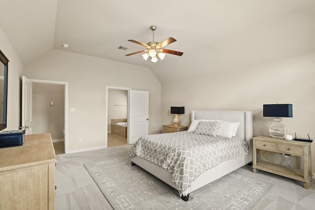 carpeted bedroom featuring vaulted ceiling, ensuite bath, and ceiling fan