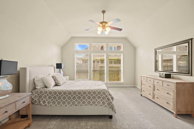 carpeted bedroom with vaulted ceiling and ceiling fan