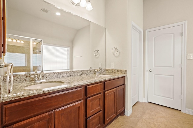 bathroom featuring tile patterned flooring, vanity, vaulted ceiling, and an enclosed shower