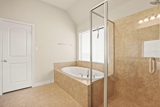 bathroom with shower with separate bathtub, tile patterned floors, and lofted ceiling