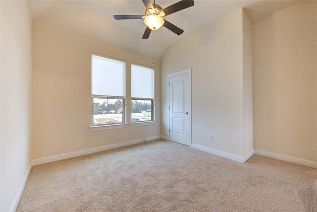 unfurnished room with ceiling fan, light carpet, and vaulted ceiling