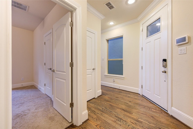 entryway with light hardwood / wood-style floors and ornamental molding