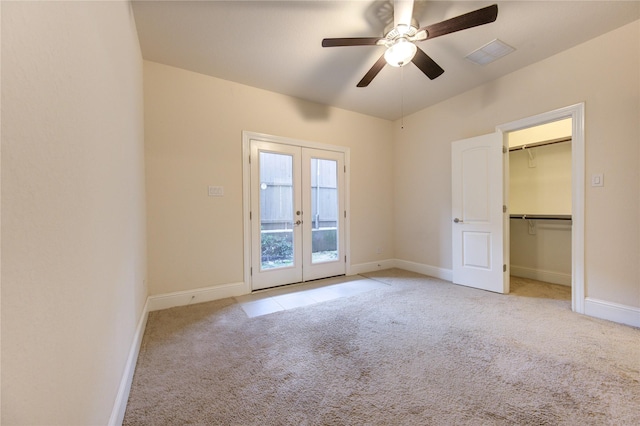 unfurnished room featuring ceiling fan, light carpet, and french doors