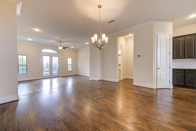 unfurnished living room featuring french doors, ceiling fan with notable chandelier, crown molding, and dark wood-type flooring