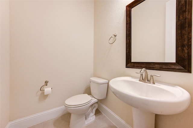 bathroom with tile patterned floors, toilet, and sink