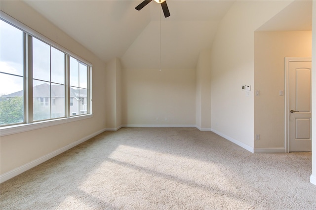 spare room featuring light colored carpet, ceiling fan, and lofted ceiling